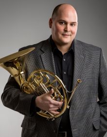Portrait of Principal French Horn musician Zachary Cooper