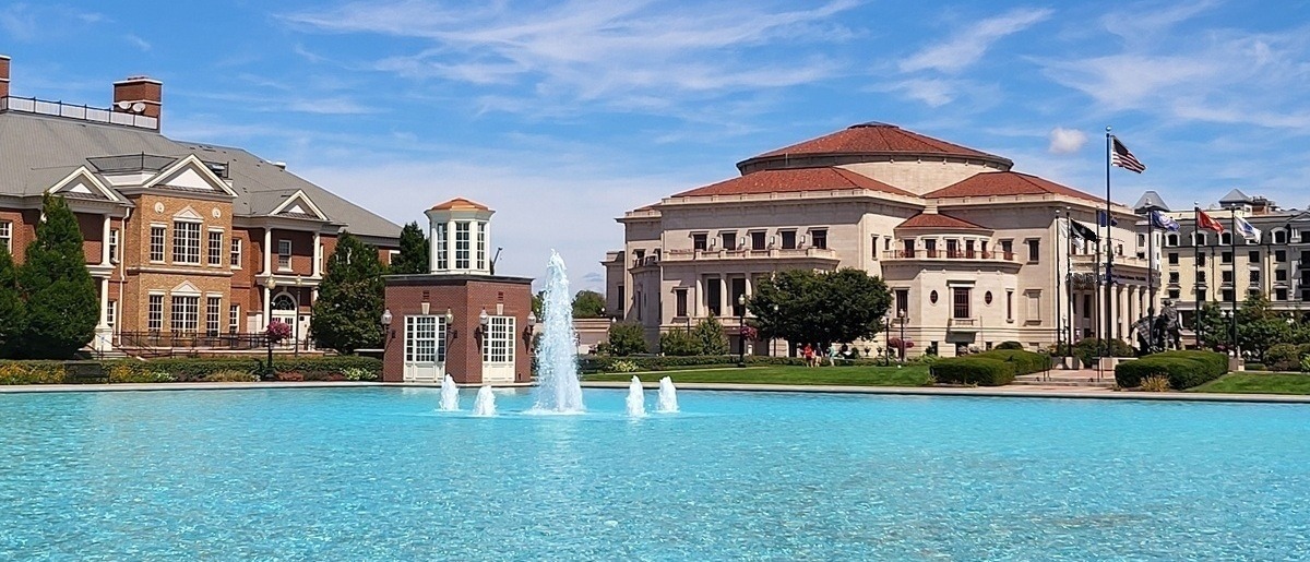 Exterior of the Payne & Mencias Palladium and Pedcor Center, home of the Carmel Symphony Offices, across the turquoise reflecting pond at City Center