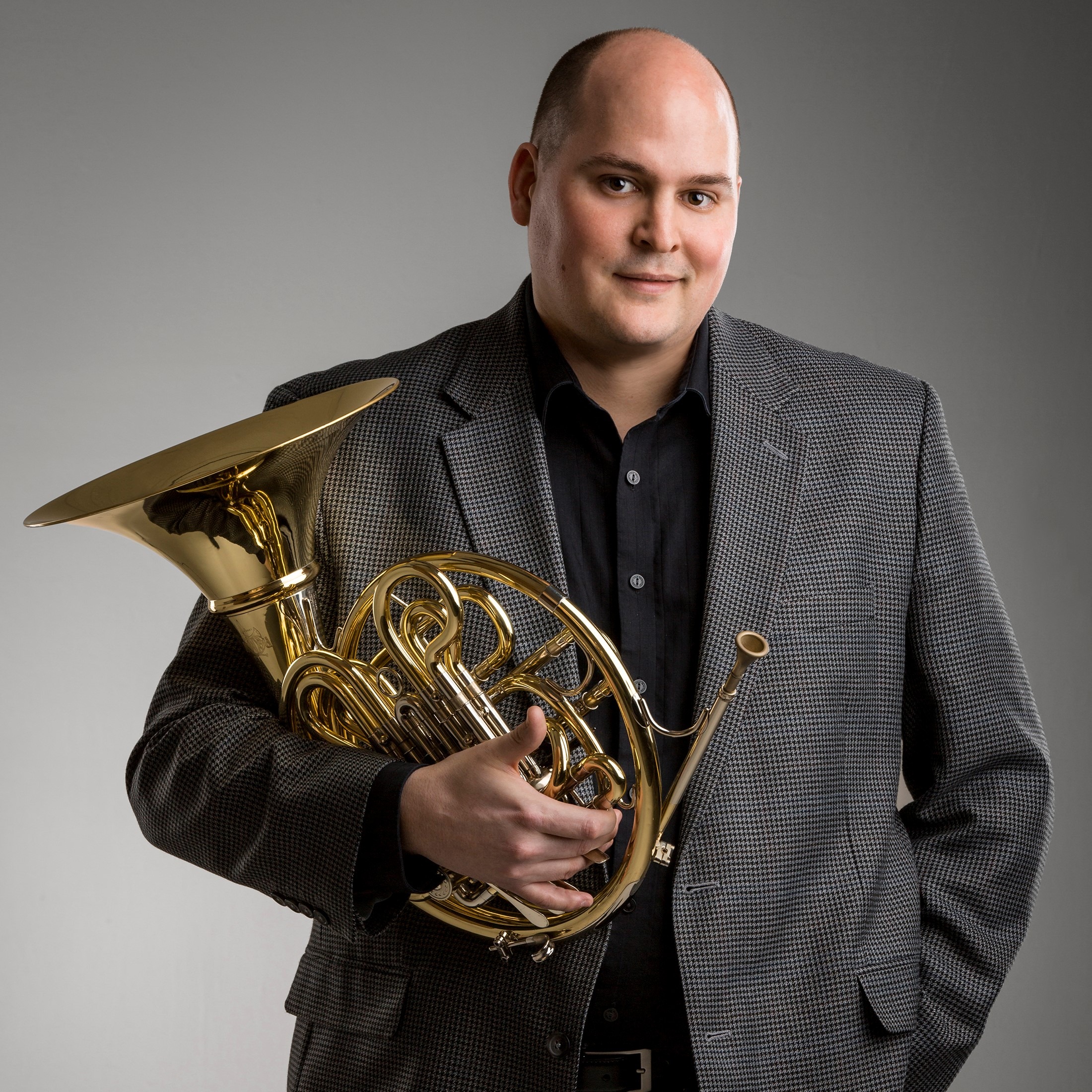 Portrait of Principal French Horn musician Zachary Cooper