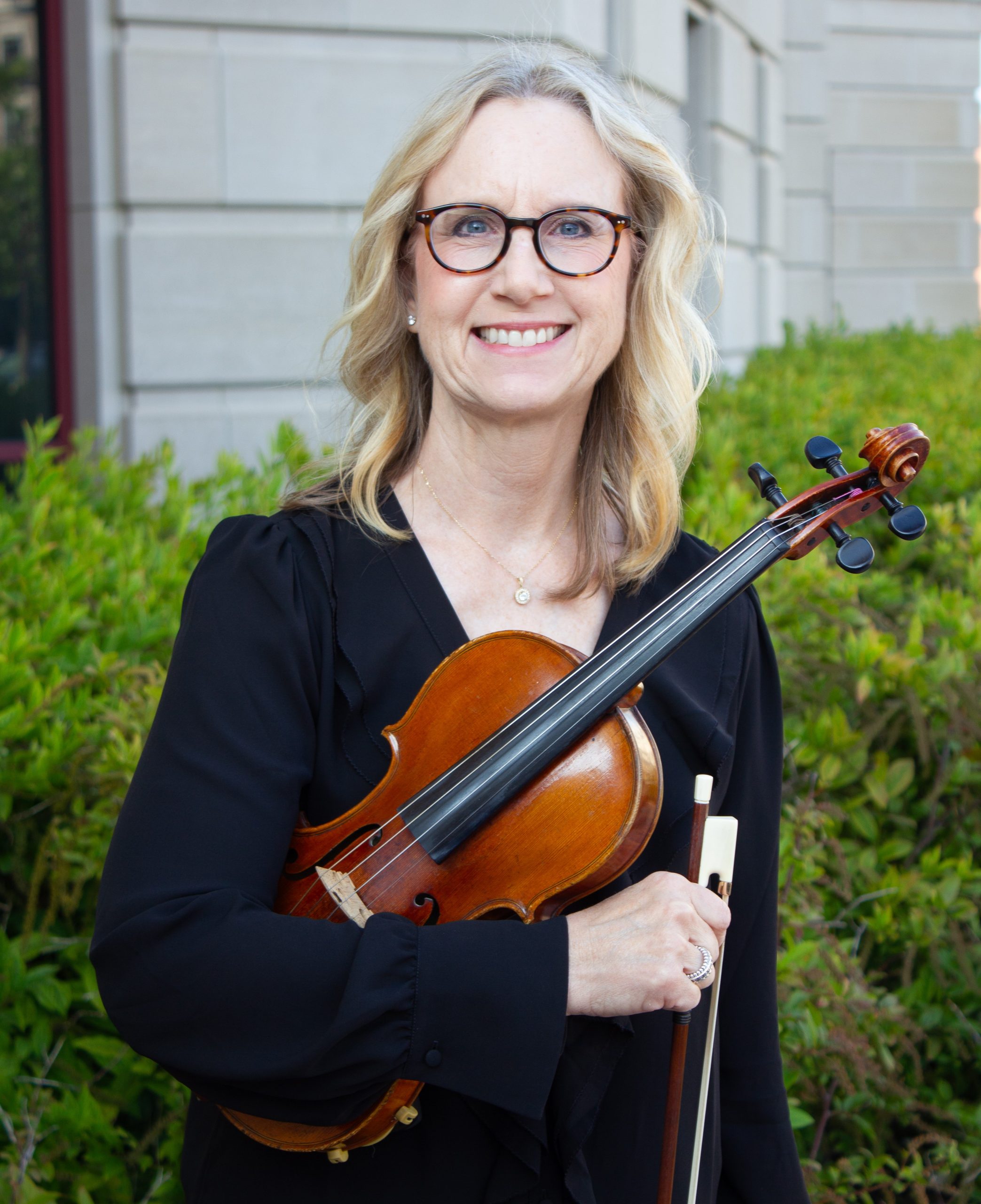 Portrait of Violin II musician Kris Zaloudek