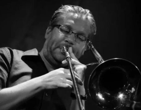 Carmel Symphony Orchestra Musician Rich Dole - black and white photo of Rich playing the trombone