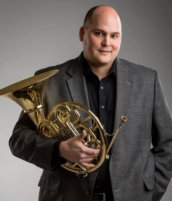 Portrait of Principal French Horn musician Zachary Cooper