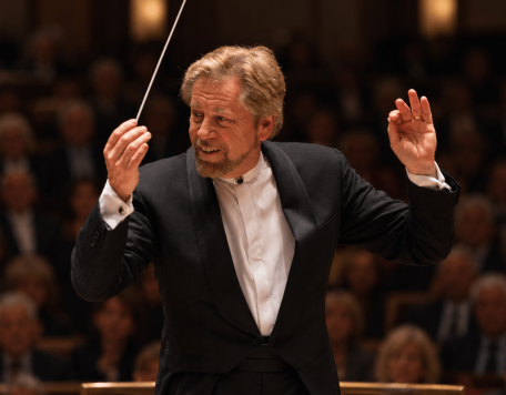 Carmel Symphony Orchestra Music Director David Commanday in tuxedo conducting