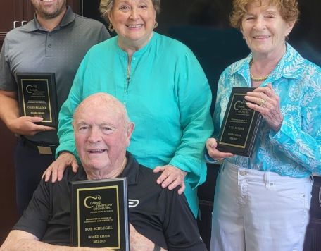 CSO Board Members pose with plaques thanking them for their service. 