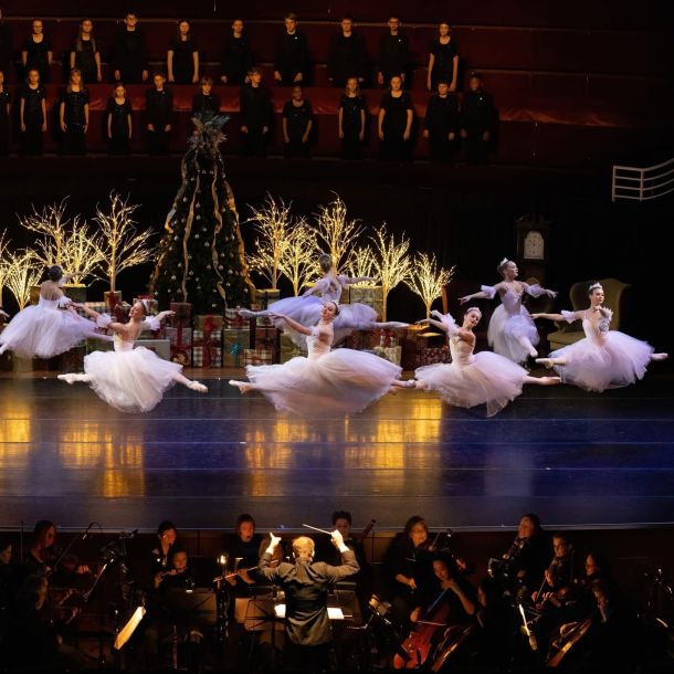 Indiana Ballet Conservatory photo with ballerinas on stage in white tutus with lighted trees in background - square size